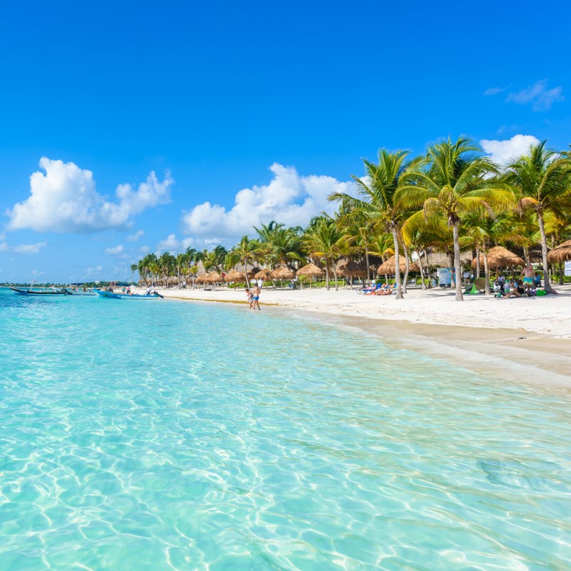 Tourists on a Beautiful White Sand Cancun Beach with Aqua Blue Water 