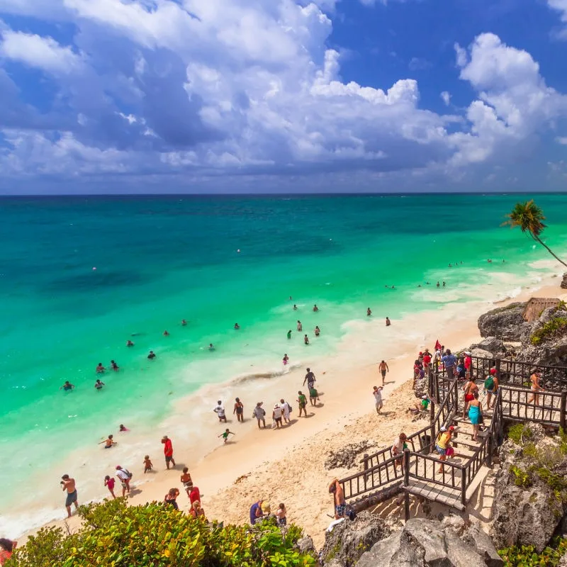 Tourists on the Beach in Front of the Tulum Ruins in Mexico