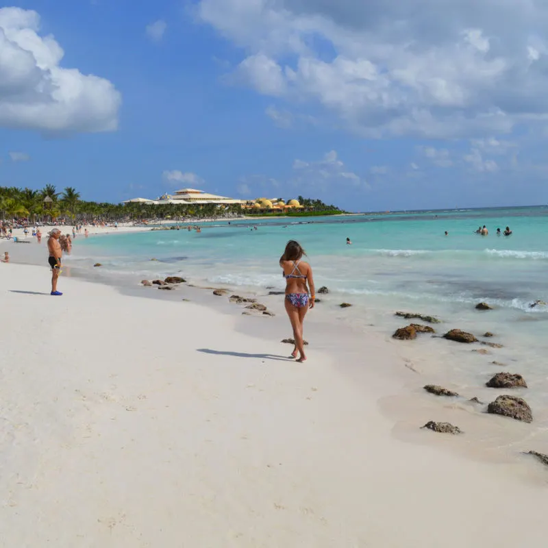 Beachgoers in a popular Playa del Carmen beach with blue water