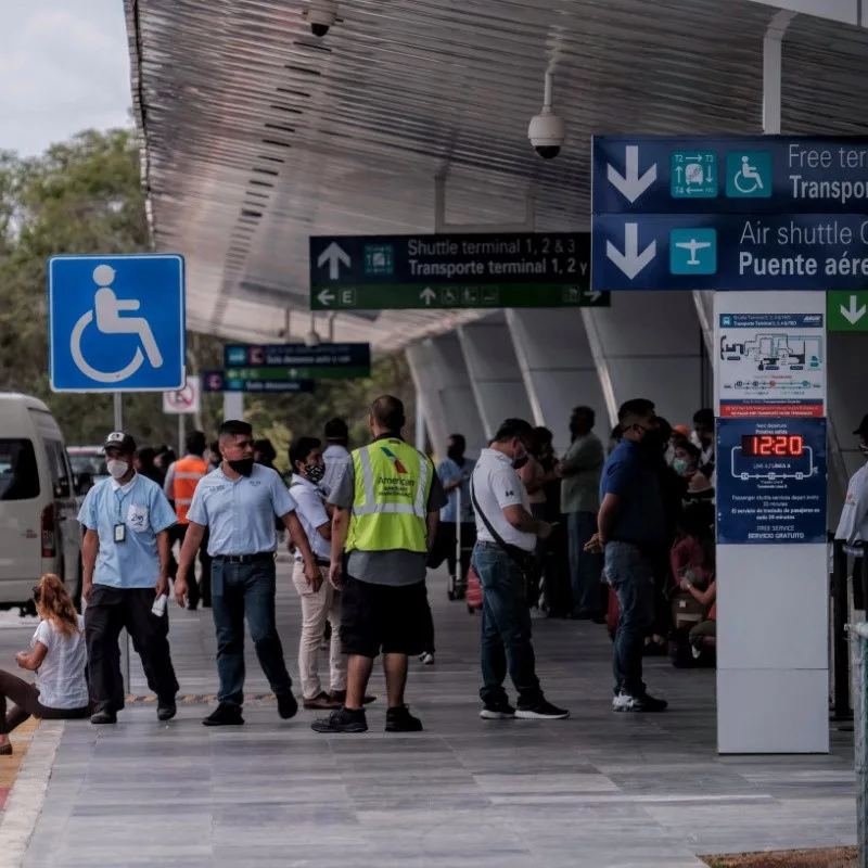 Travelers Waiting Outside of Cancun Airport