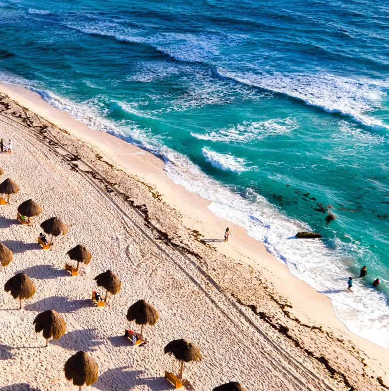 Travelers walking along playa delfines in cancun mexico