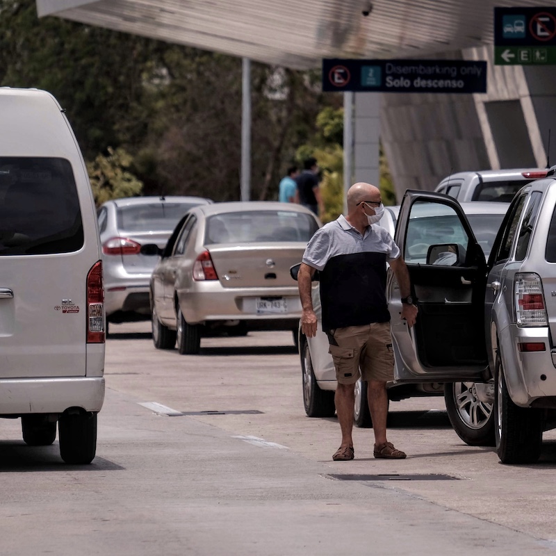 All types of vehicles at the Cancun Airport drop-off.