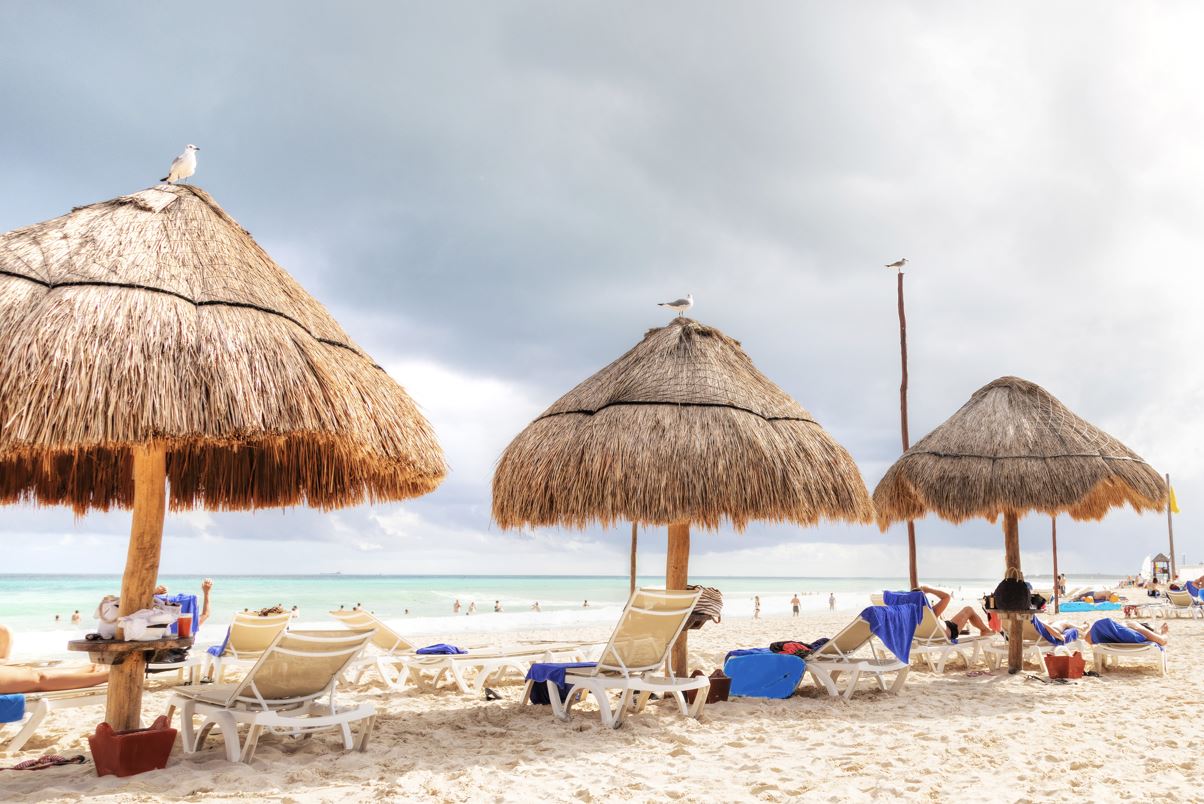 tiki umbrella shade at cancun beach on sunny day