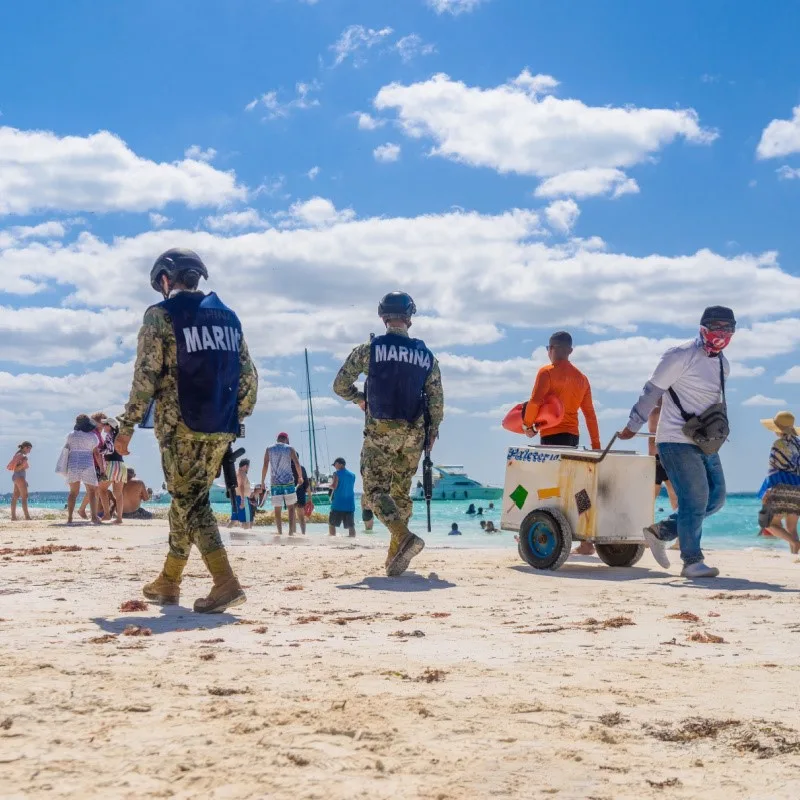 Beach Vendor and Municipal Police on a Beach in Isla Mujeres