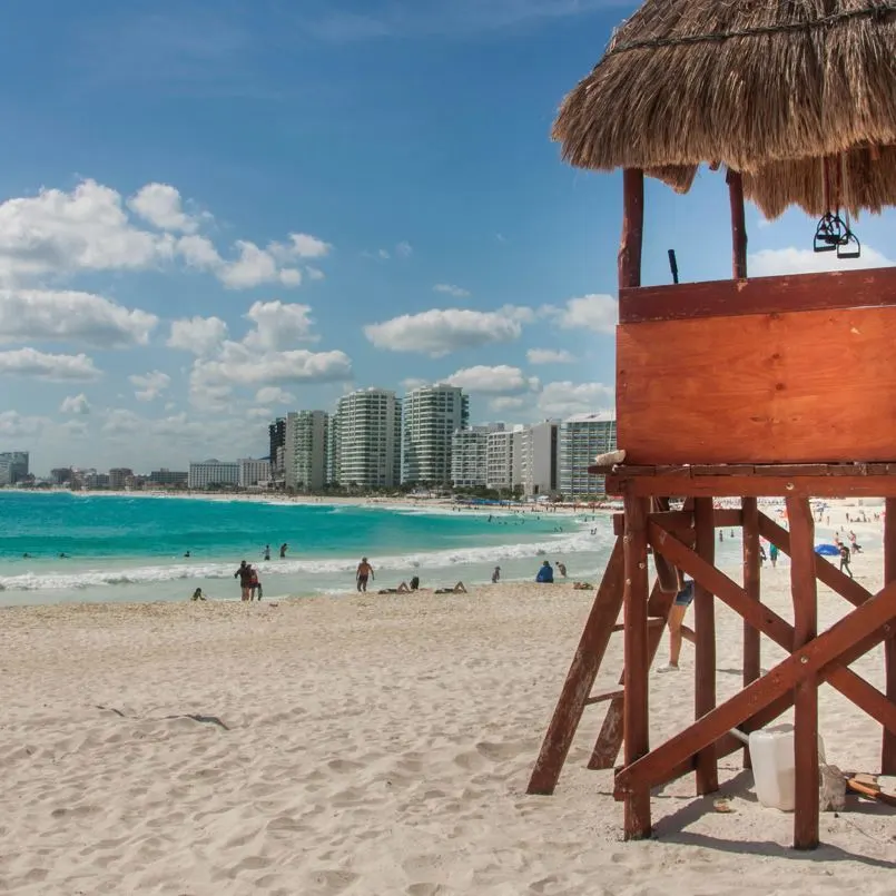 Cancun beach lifeguard shack with beach tourists in the background