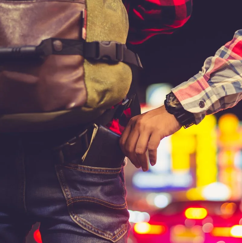 Pickpocket taking a persons wallet