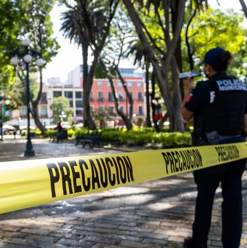 Police officer guards a crime scene cordon