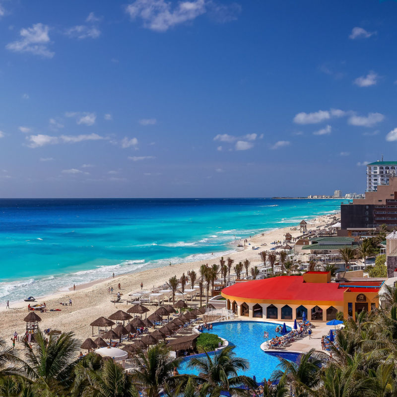 Outdoor view of a Cancun resort with pools and a beach 