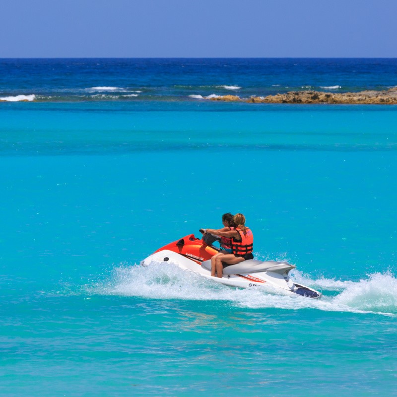 Tourists on jet skis in the turquoise waters of Cancun