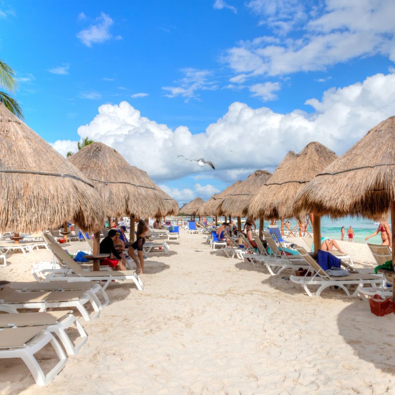 Tourists on the Beach in Lounge Chairs in Cancun, Mexico