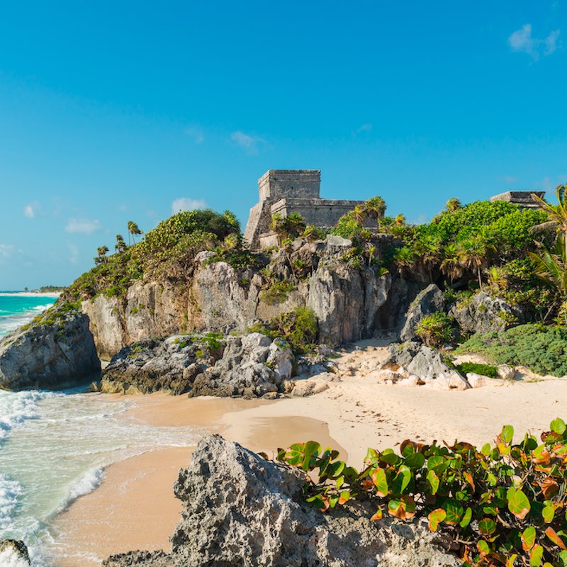 sunny day Tulum ruins by the beach.