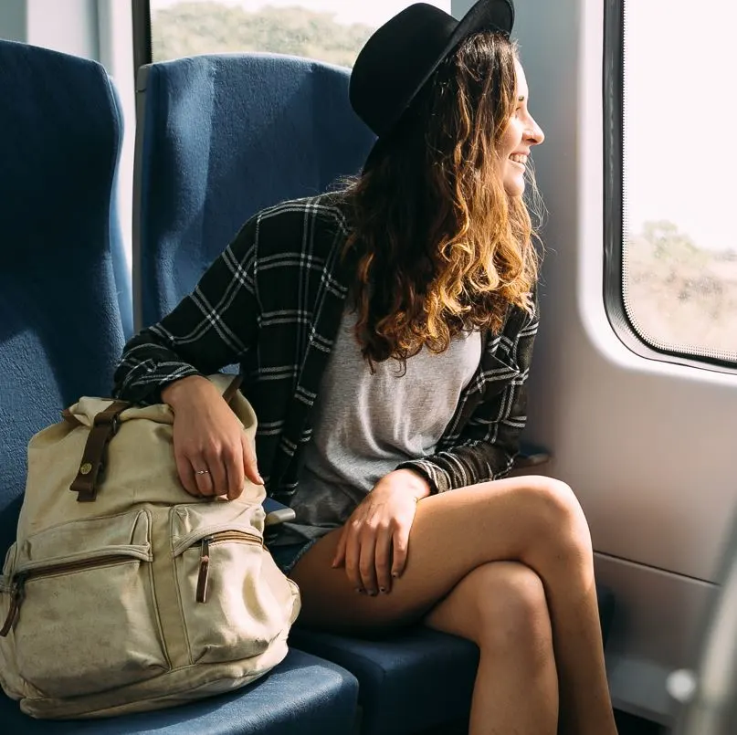 Woman sitting in train looking out of the window