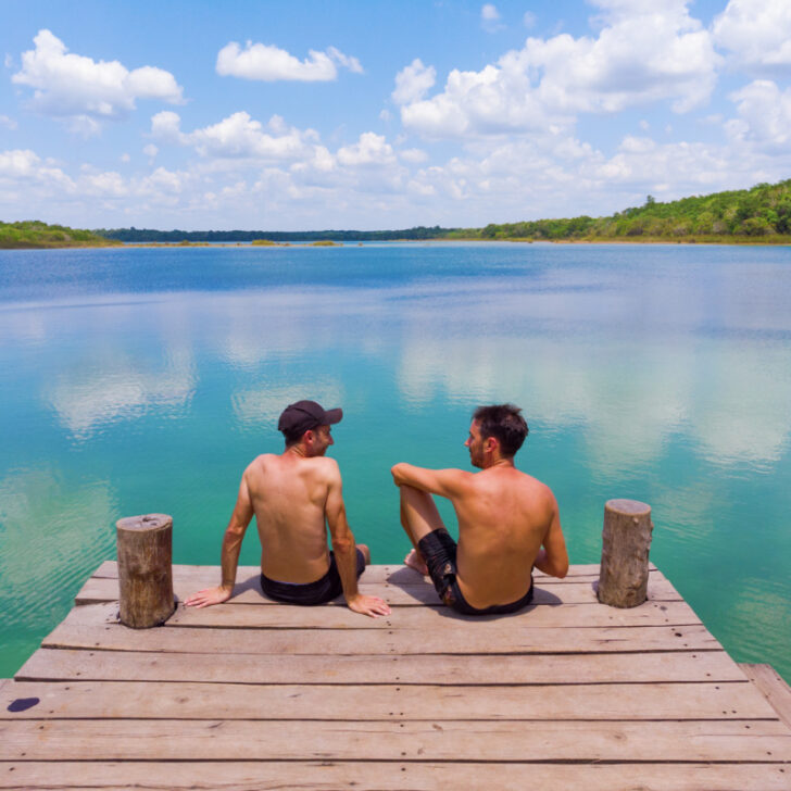 Two men on a pier enjoying the lake view
