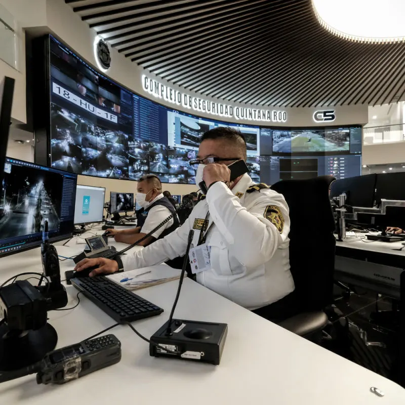 Shot of the C5 operation centre in Cancun with a police officer 
