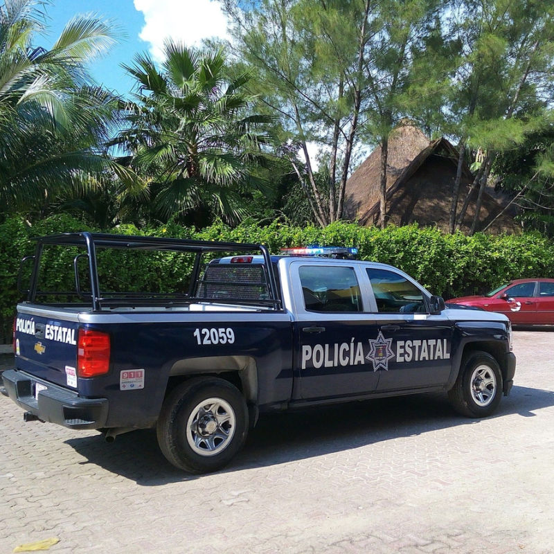 A Cancun police car parked on a local road