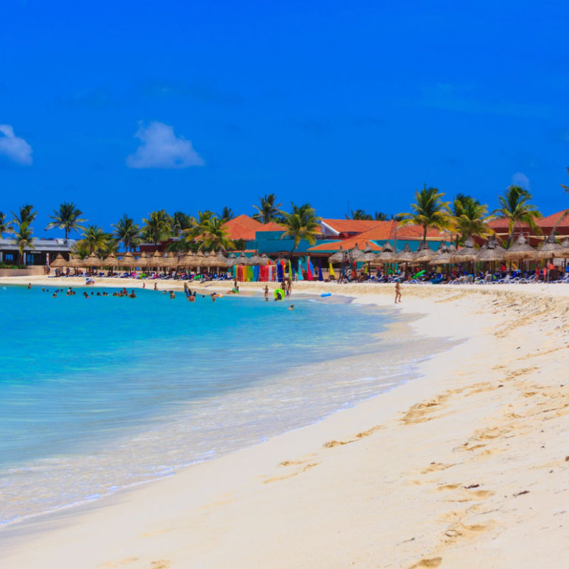 A beach in the Mexican Caribbean with blue skies and waters