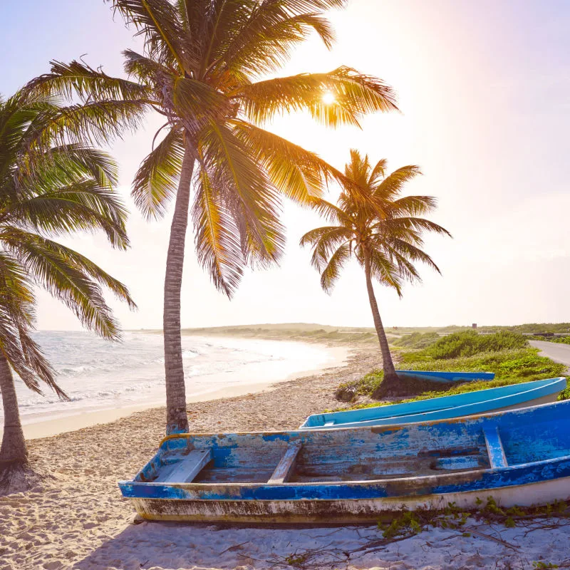 White sand beach and an abandoned wood boat in Cozumel