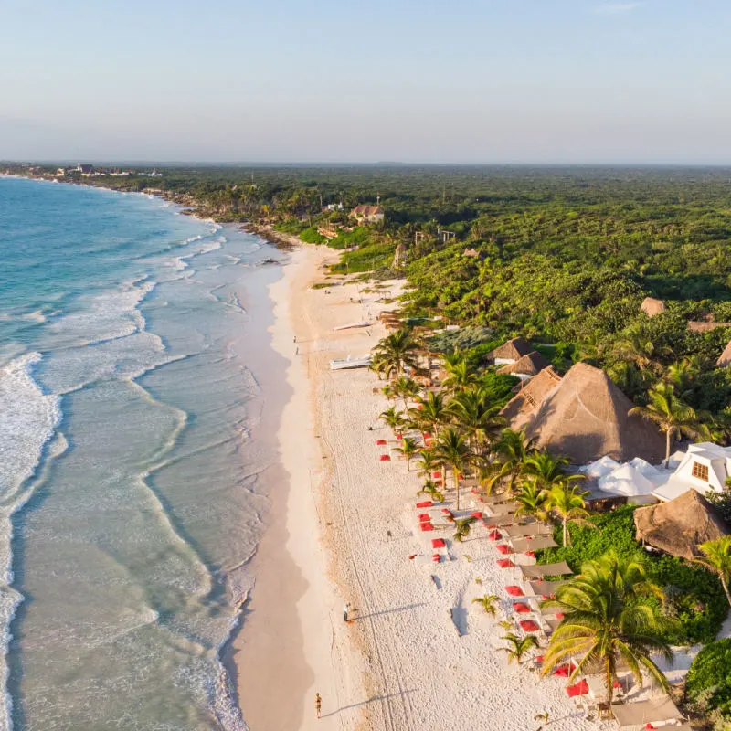 Isla Mujeres coastline with white sand shore and trees 