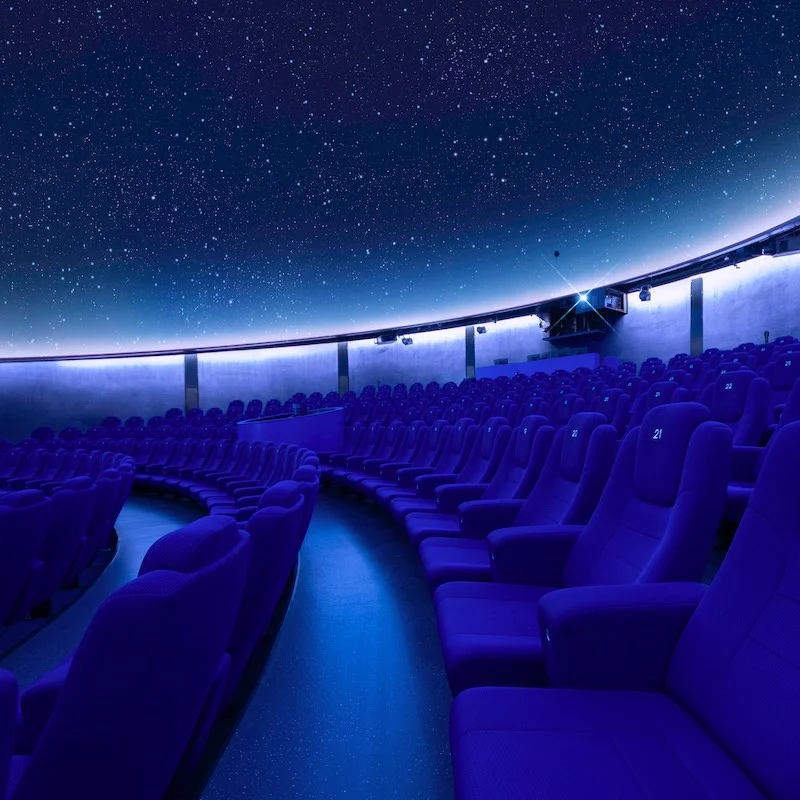 A breathtaking star projection at the planetarium with comfortable seats.