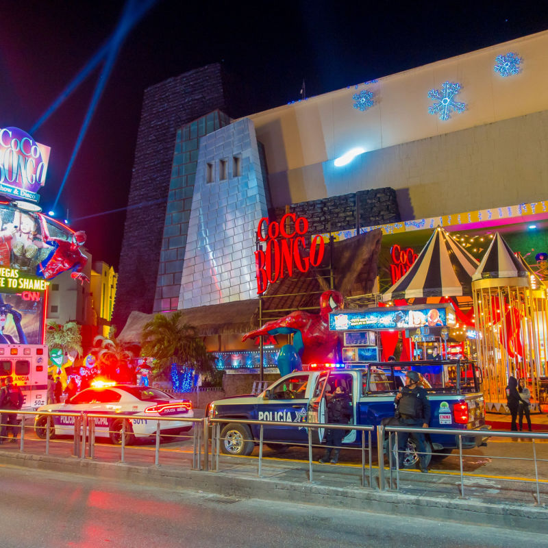 Cancun's busy nightlife area with police cars and light 