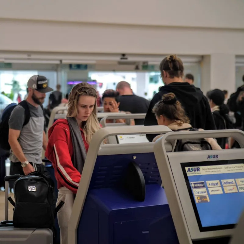 Tourists Using the Kiosks at Cancun International Airport