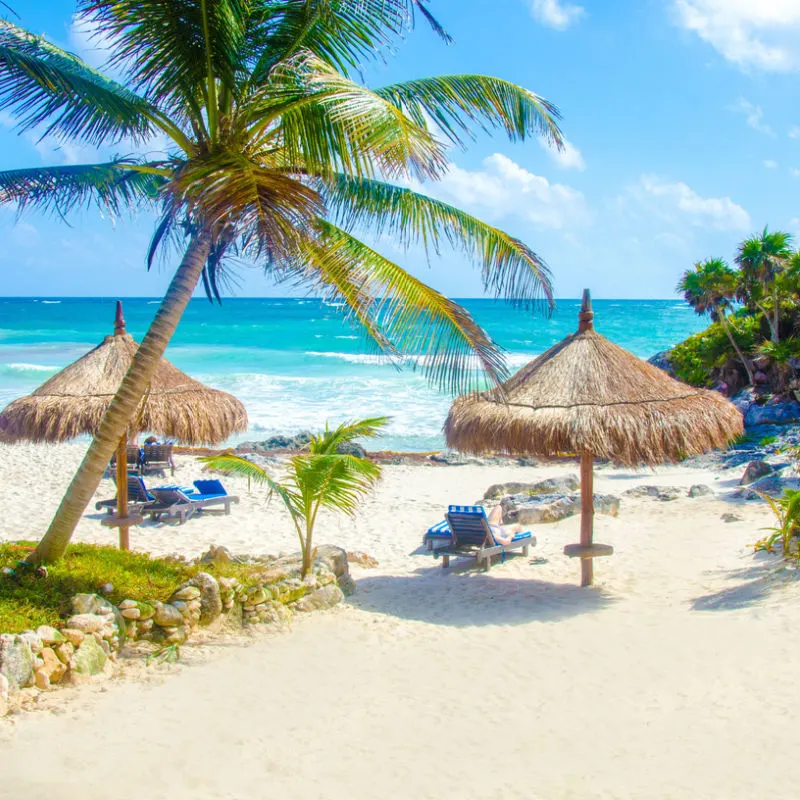 A small remote beach in Cancun with sunshades 