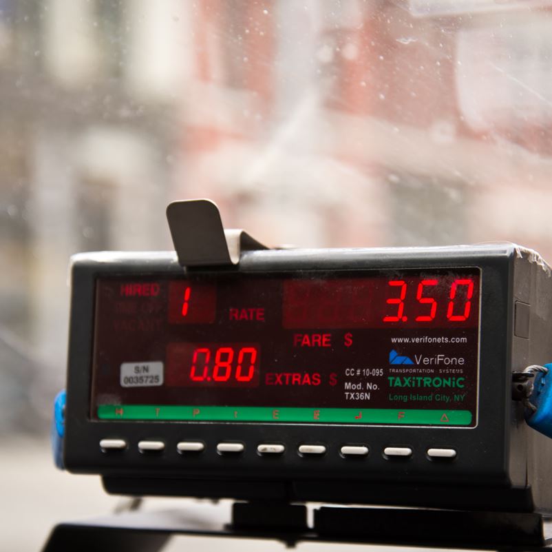 A taxi meter in a cab