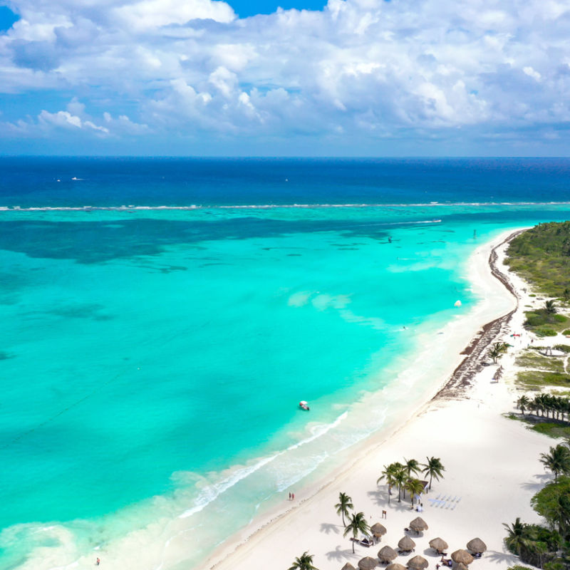 Aerial view of the Riviera Maya with a white sand beach and blue water