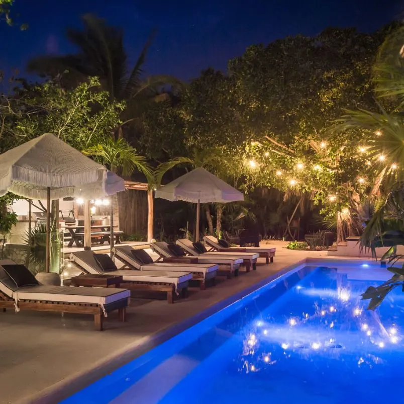 Casa Cenote villa pool area at night