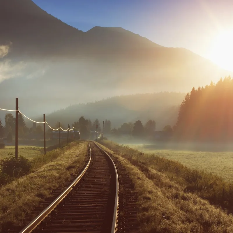 train tracks during sunrise 