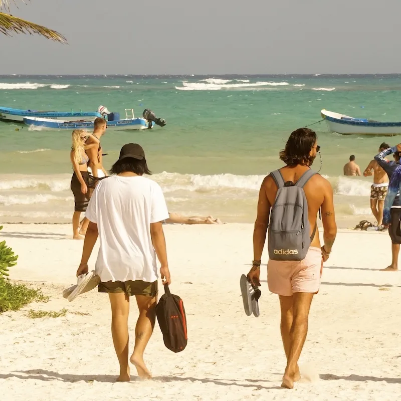 travelers on a beach in tulum