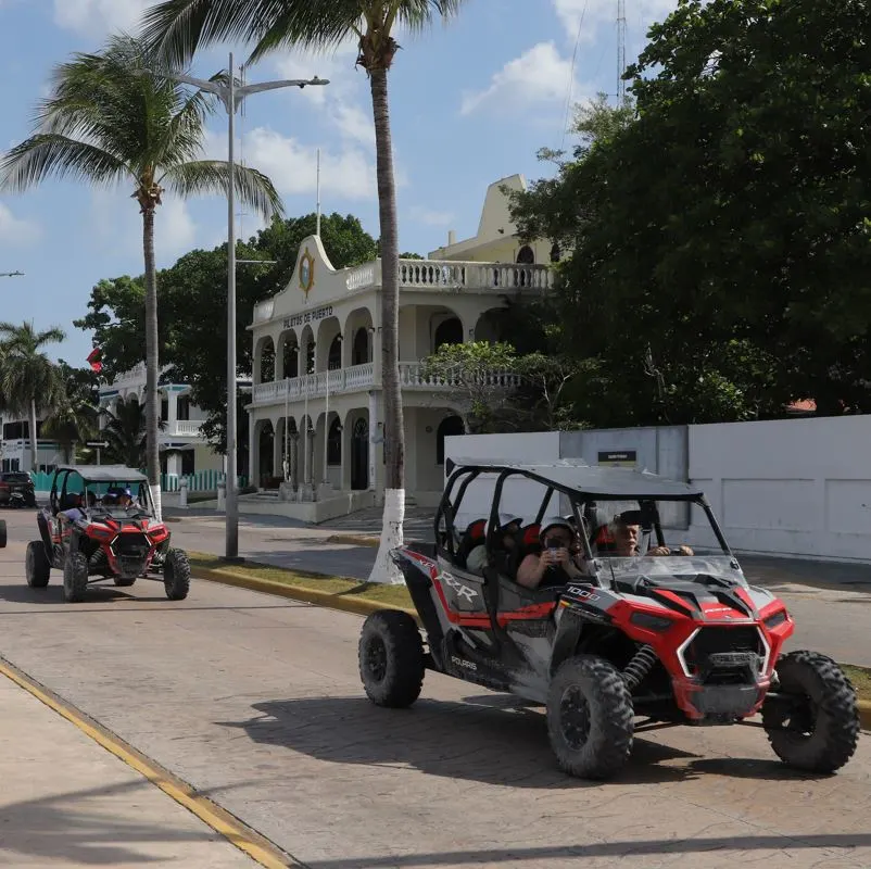 Beach buggy tour group driving down a road in Mexico