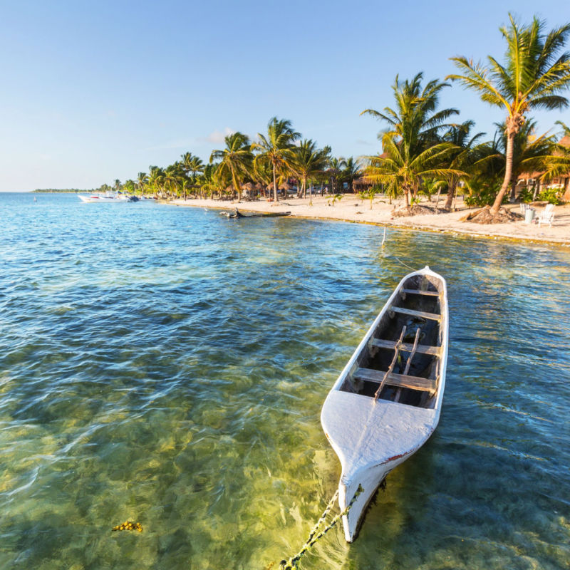 A small boat floating on the water in the Mexican Caribbean 