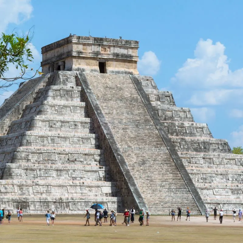 Chichen Itza with many tourists in the area