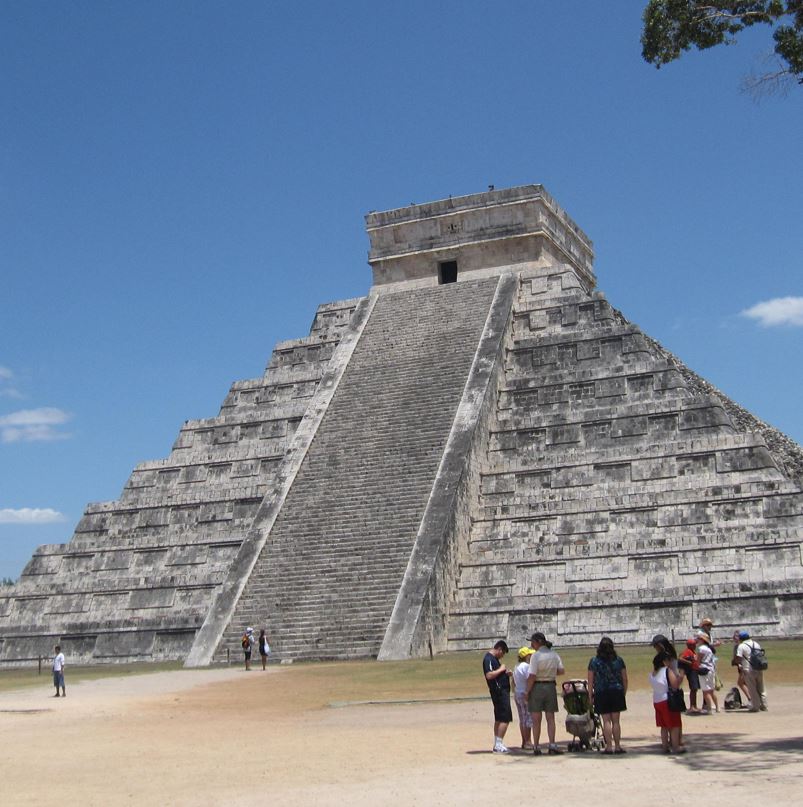 Chichen itza pyramid with people in front of it