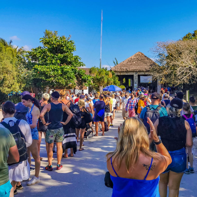 Long line of the tourists at the entrance of Tulum