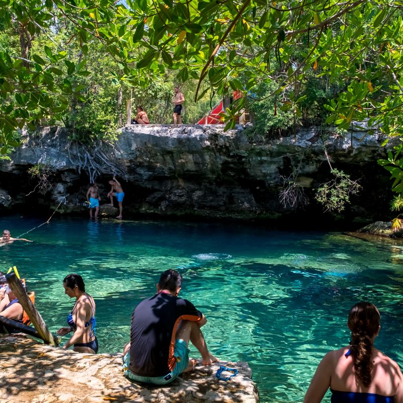 Travelers enjoying a cenote in mexico