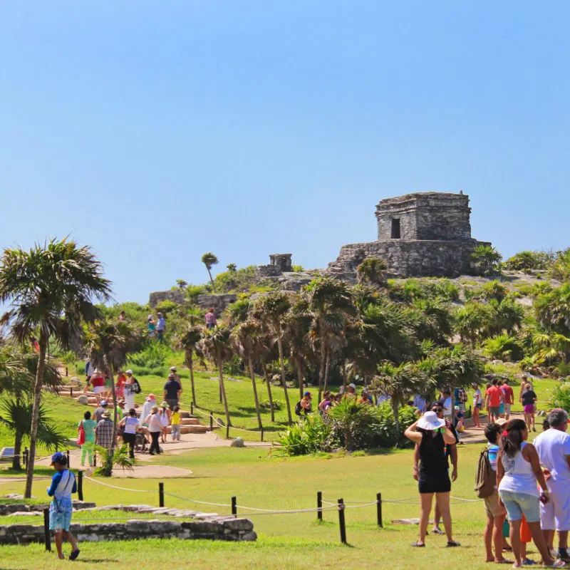 Tourists walking around the Maya Ruins in Tulum