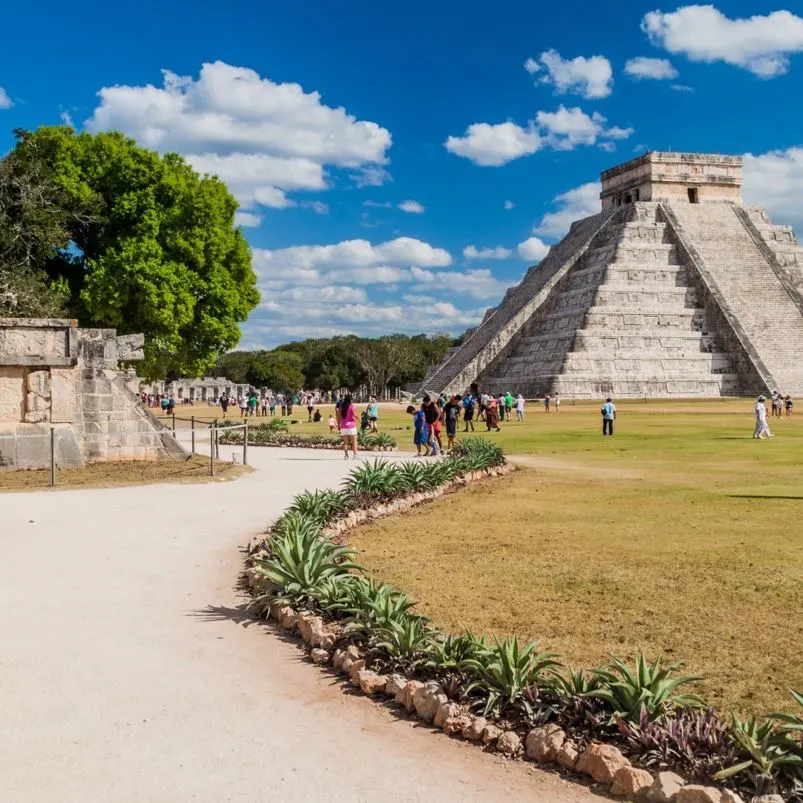 Visitors looking at chichen itza