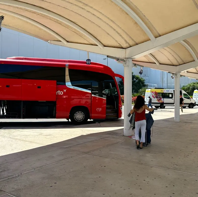 Woman walking towards a bus at cancun airport