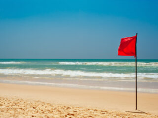 red flag warning on beach