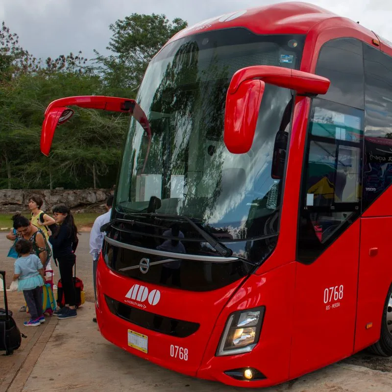 Tourists Waiting For An ADO Bus