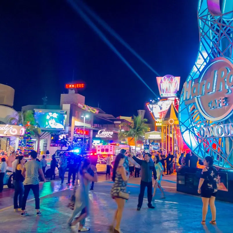 A street in cancun at night with neon lights 