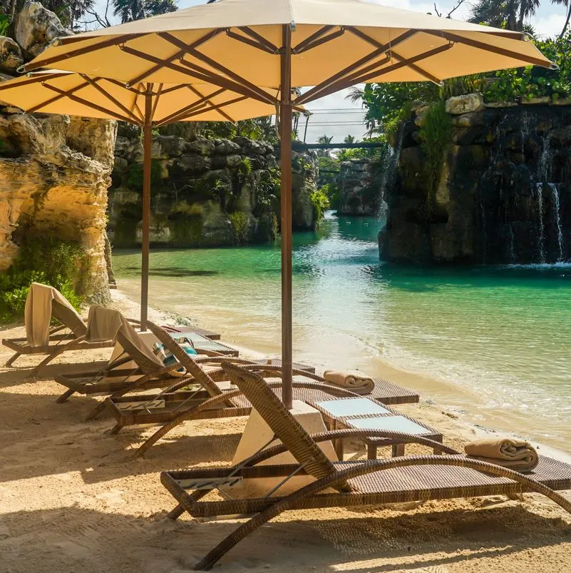 A lush outdoor pool in Xcaret with blue water