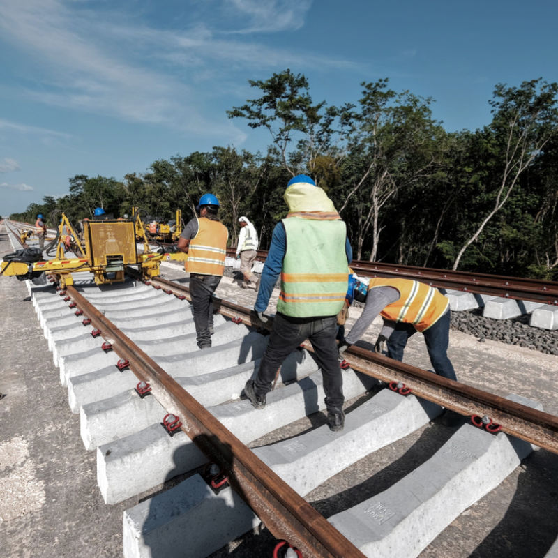 Workers building the Maya Train tracks