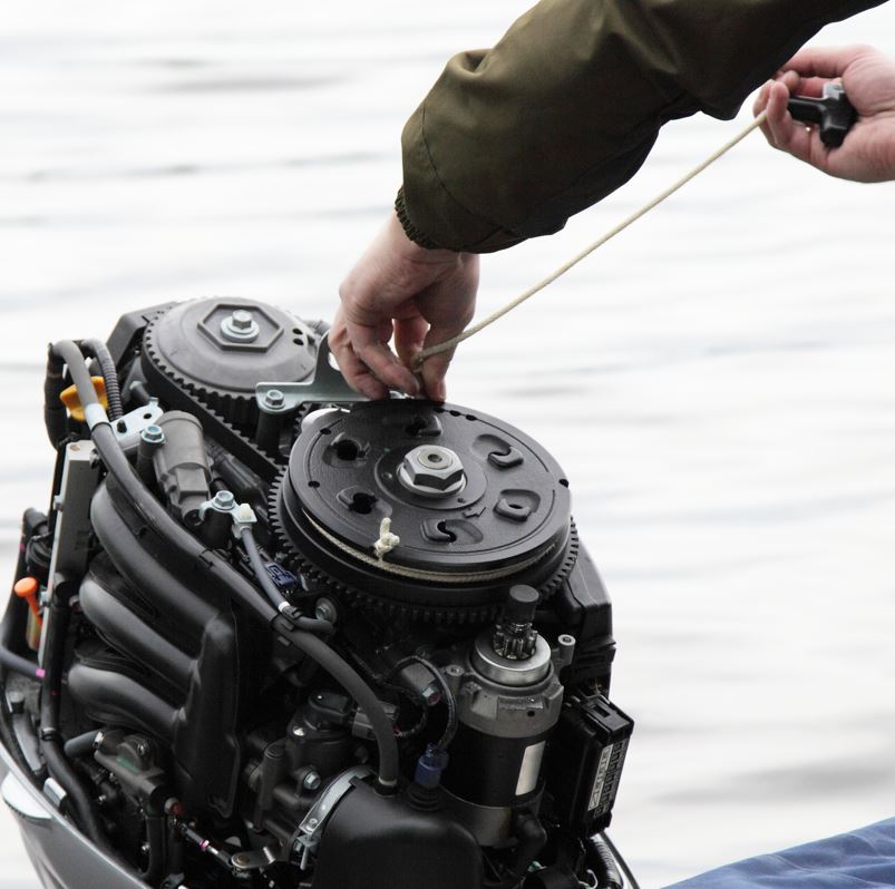 Maintenance being performed on an outboard motor