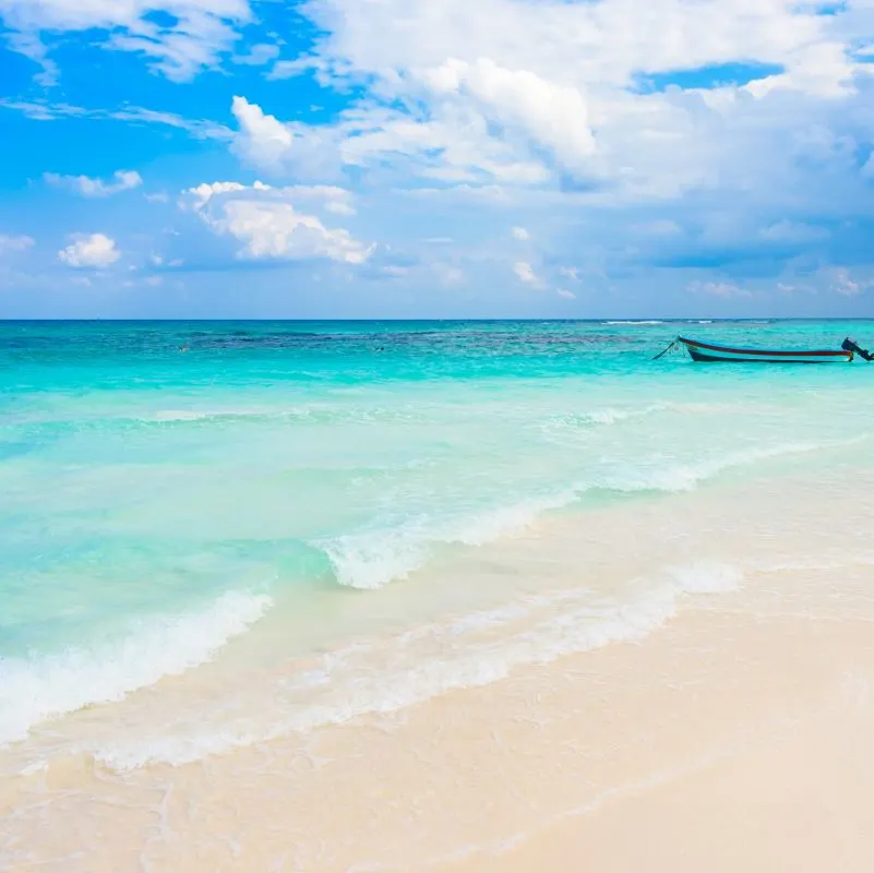 A small fishing boat at the coast of Playa Xpu-Ha