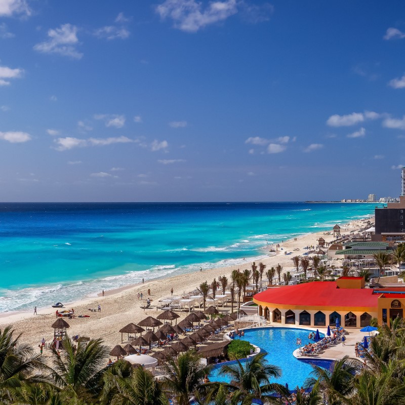 Beautiful Tropical Resort and Tourists Enjoying the Beach in Cancun, Mexico