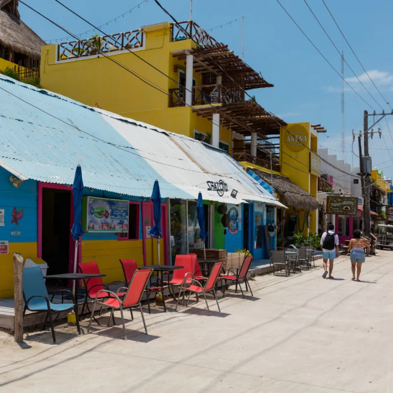 Tourists Walking Down a Sandy Road on the Island of Holbox in the Mexican Caribbean