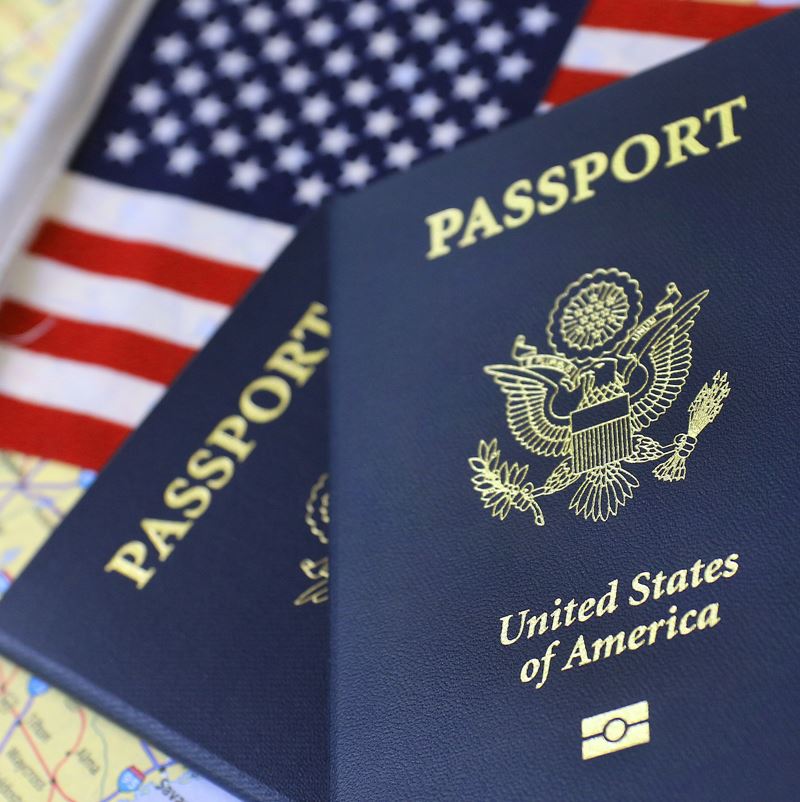 US passports with the star spangled banner in background